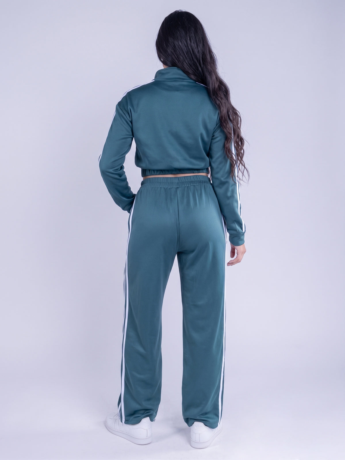 Conjunto deportivo verde con franjas laterales