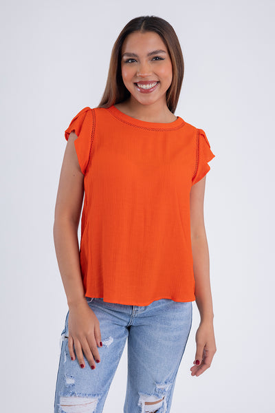 Blusa naranja con detalle de botones en espalda
