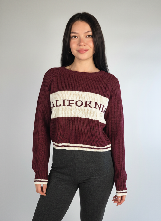 Suéter tejido guinda con franja blanca de leyenda