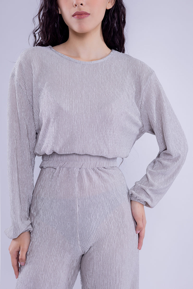 Conjunto brilloso de blusa y pantalón