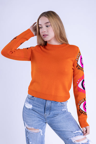 Suéter naranja con estampado de ojos en mangas