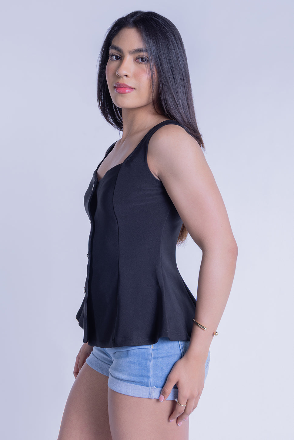 Blusa negra de tirantes seccionada con botones metalicos